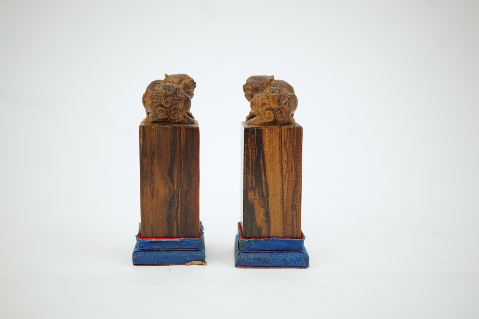 A cased pair of Chinese hardwood ‘lion-dog’ seals, early 20th century